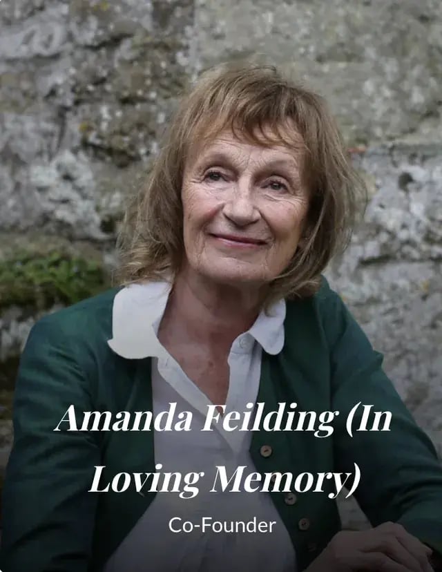 Amanda Feilding in a garden beside a stone doorway