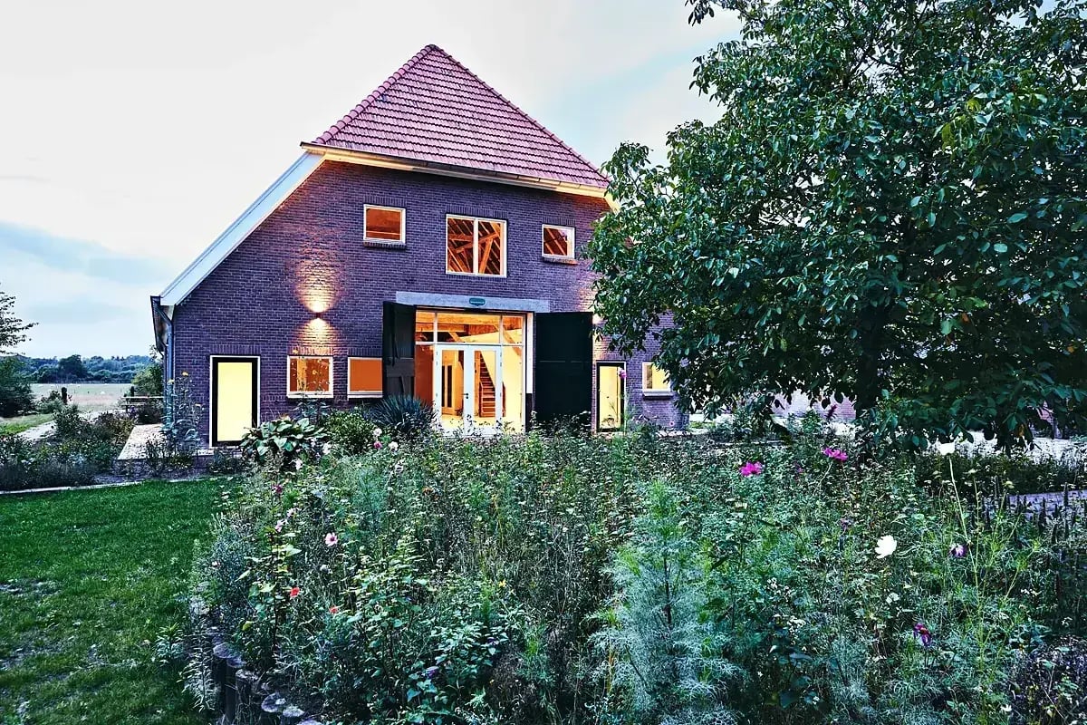 The rebuilt farmhouse at The Place To Be in evening light