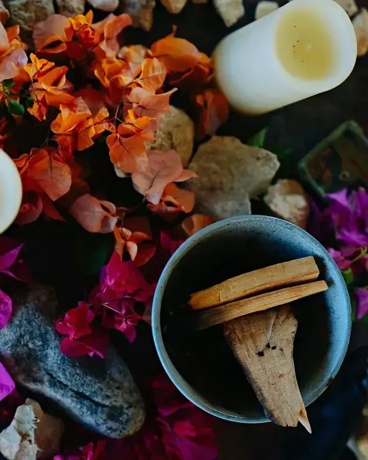 Candles, flowers and a bowl prepared for a session